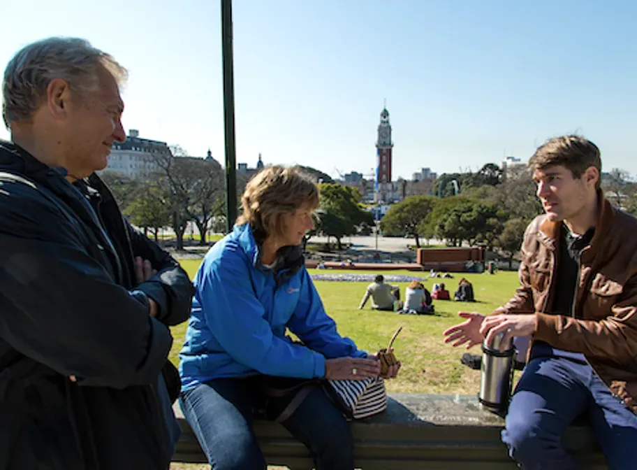 A BuenosTours guide sharing mate with two private-tour guests overlooking Plaza San Martín in Buenos Aires